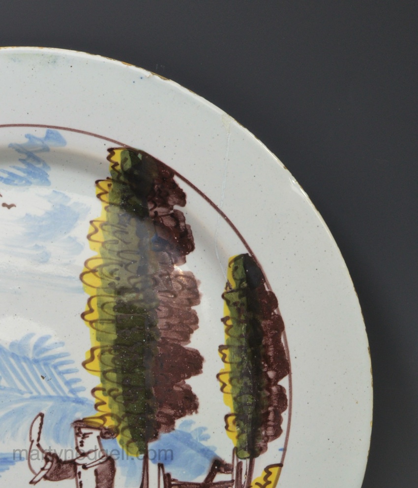 Liverpool delft plate painted with a couple in a rural setting, circa 1750