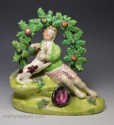 Staffordshire pearlware pottery bocage figure boy and dog, circa 1820