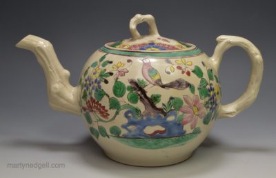White saltglaze teapot decorated with colours over the glaze, circa 1760