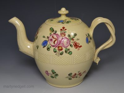Creamware pottery teapot decorated with over glaze floral enamels, circa 1780