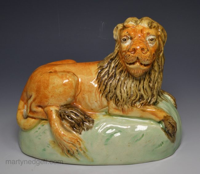 Creamware pottery lion decorated with colours under the glaze, circa 1800