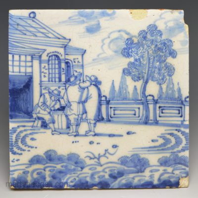 London delft tile decorated in blue with a scene of three men, circa 1730