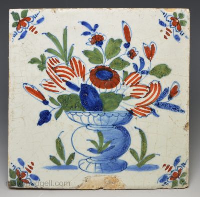 London delft tile decorated in florals and colour over the glaze, circa 1730