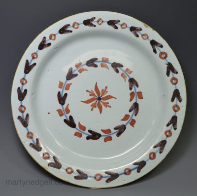 London delft pancake plate decorated with red and manganese, circa 1740