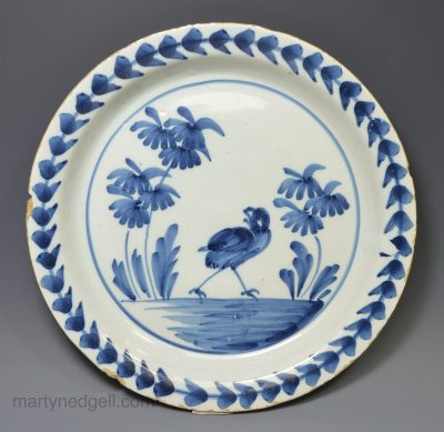 London delft pancake plate decorated with a bird, circa 1740