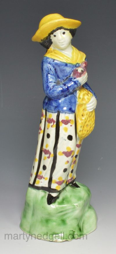 Pearlware pottery figure of a woman and a bird, circa 1800