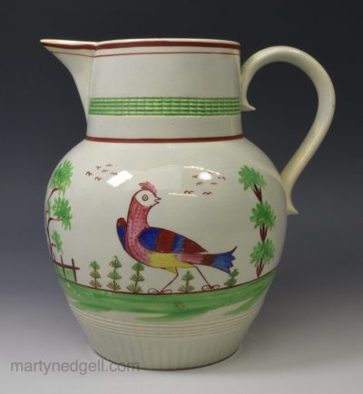 Pearlware pottery jug decorated with a bird under the glaze, circa 1810