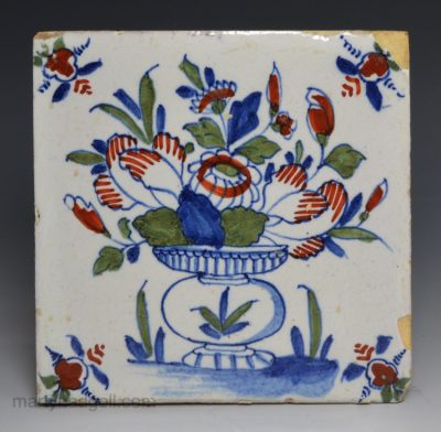 London delft tile decorated in blue, red and green florals, circa 1730