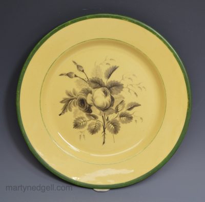 Buff coloured pottery plate painted with a rose, circa 1800, Leeds Pottery