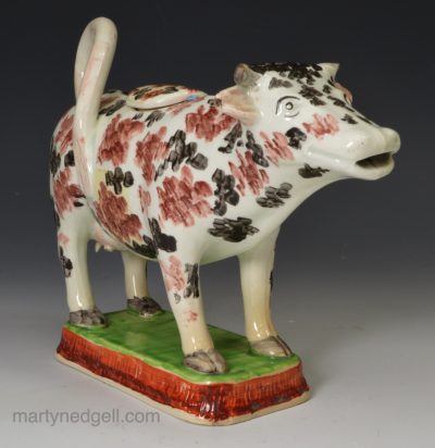 Pearlware pottery cow creamer decorated with colour over the glaze, circa 1830