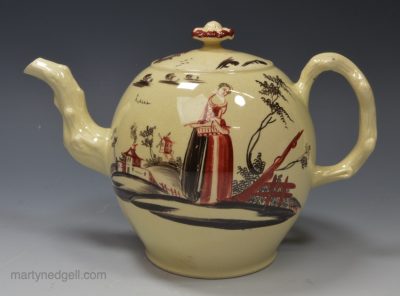 Creamware pottery teapot decorated in black and red, circa 1770