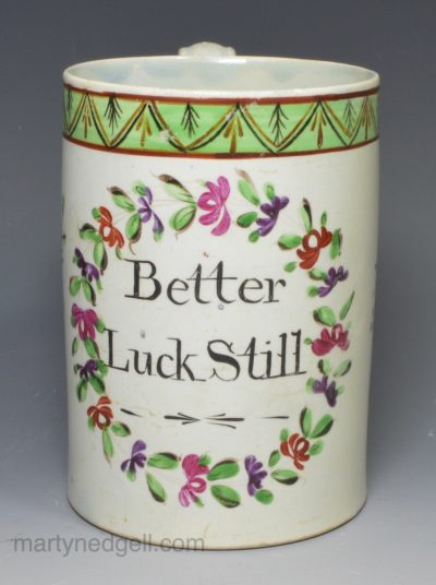 Pearlware pottery mug decorated in colours over the glaze 'Better Luck Still', circa 1820