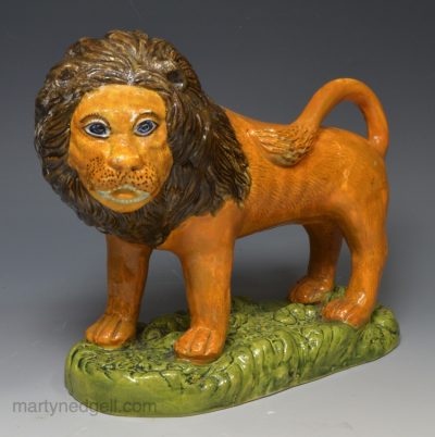 Pearlware pottery figure of a lion decorated with colours under the glaze, circa 1810