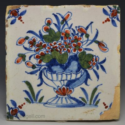 London delft tile decorated in blue, red and green florals, circa 1730