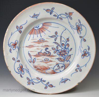London delft plate painted with a sun shining on a duck in a lake, circa 1740