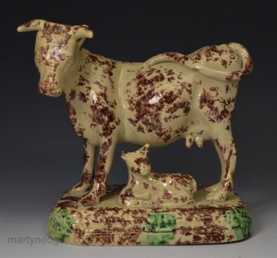 Yorkshire type buff coloured pottery model of a cow and calf, circa 1820