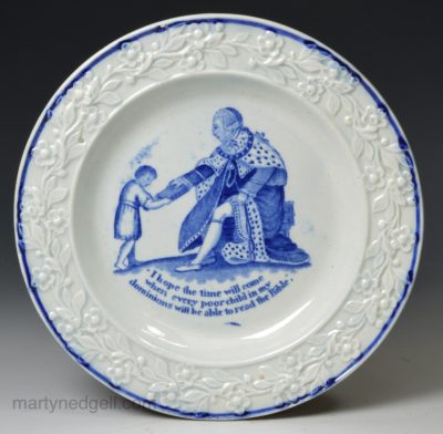 Pearlware pottery child's plate decorated with a print of George III giving a bible to a young boy, circa 1815