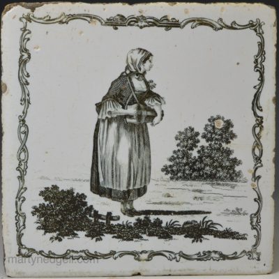 Liverpool delft tile decorated with a Sadler print of a girl playing a hurdy-gurdy, circa 1770