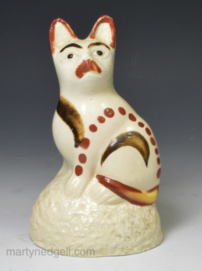 Creamware model of a cat decorated with painted slip, circa 1800 Bovey Tracey Pottery