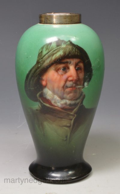 Porcelain vase decorated in green with a print of a Cornish fisherman, circa 1911