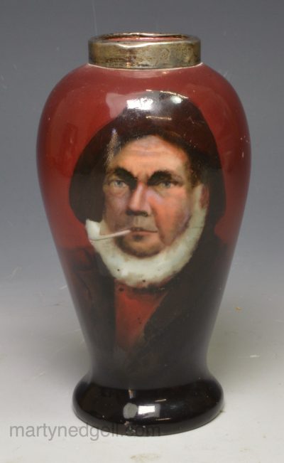 Porcelain vase decorated in red with a print of a Cornish fisherman, circa 1911