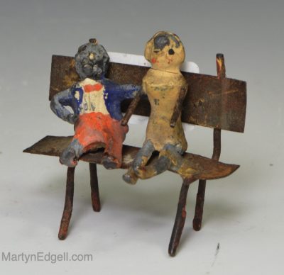 Metal figure of doll and golly, circa 1880
