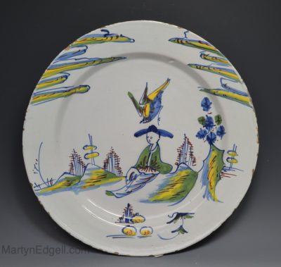 London delft charger painted in polychrome with a Chinese sage in a landscape, circa 1740
