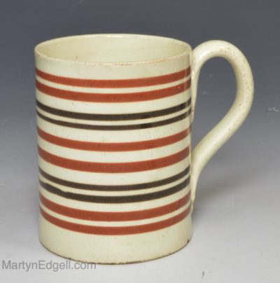 Creamware pottery small mug decorated with bands of slip, circa 1800