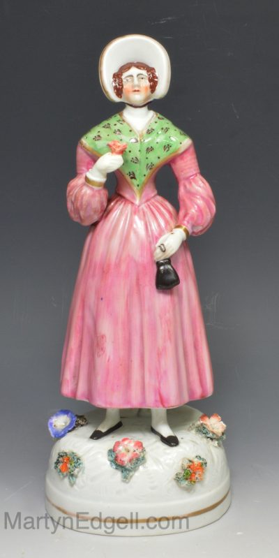 Staffordshire porcelain figure of a lady holding a flower, circa 1840
