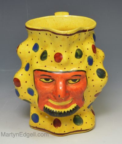 Canary yellow satyr jug decorated in colours over the glaze, circa 1820
