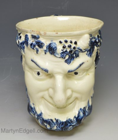 Creamware pottery satyr mug decorated with blue under the glaze, circa 1790
