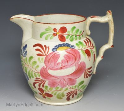 Pearlware pottery jug painted florals and colours over the glaze, circa 1820