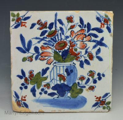 London delft tile decorated in blue, red and green florals, circa 1730