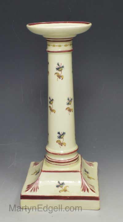 Creamware pottery candle stick painted with florals over the glaze, circa 1800