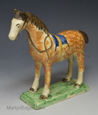 Pearlware pottery figure of a horse decorated with colours under the glaze, circa 1820