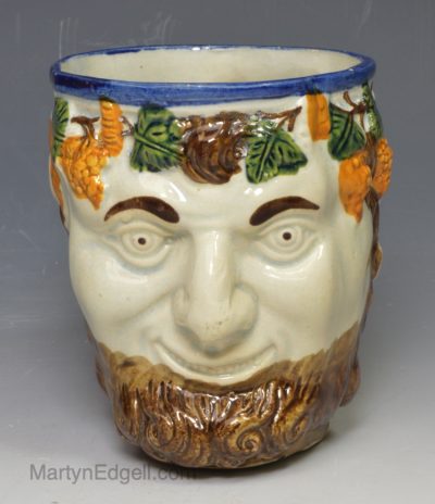 Prattware pottery satyr mug decorated with colours under the glaze, circa 1820