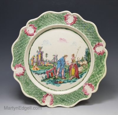 Staffordshire saltglaze stoneware plate decorated with a fortune teller with overglaze enamels, circa 1760