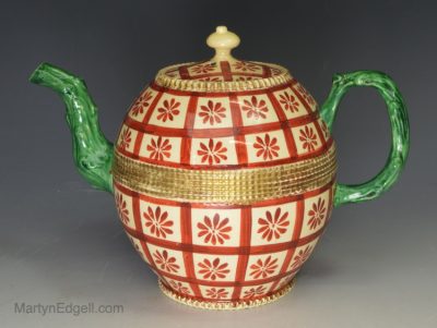 Creamware pottery tea pot painted in red and green over the glaze, circa 1760