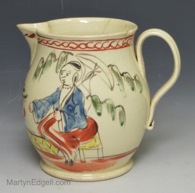 Small creamware pottery jug decorated with enamels over the glaze, circa 1770