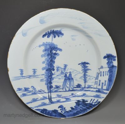 Bristol delft charger painted with a couple in blue, circa 1740
