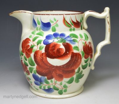 Pearlware pottery jug painted florals and colours over the glaze, circa 1820