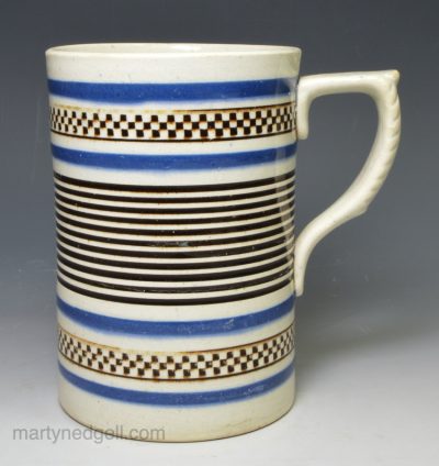 Mochaware pottery mug decorated with inlaid brown and blue slip, circa 1840