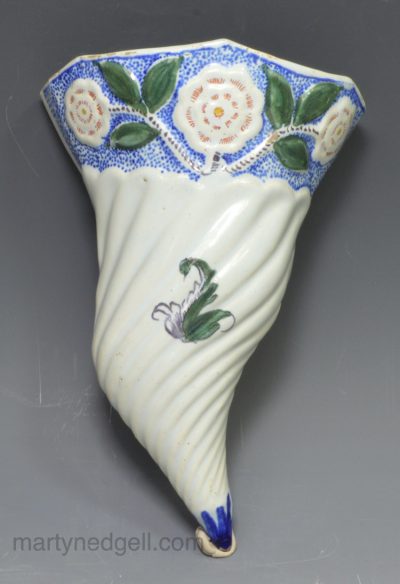 English delft wall pocket decorated with florals, circa 1760