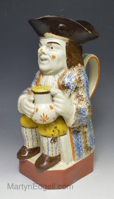 Prattware pottery Toby jug with hat decorated with colours under the glaze, circa 1820