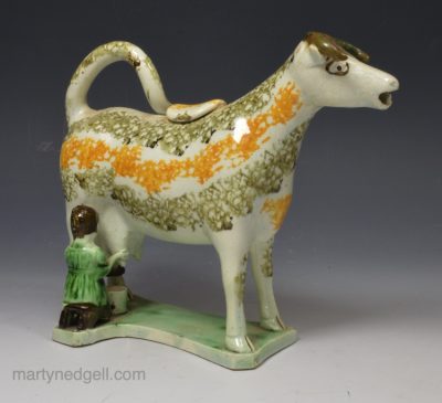 Prattware pottery hobbled cow creamer, circa 1820