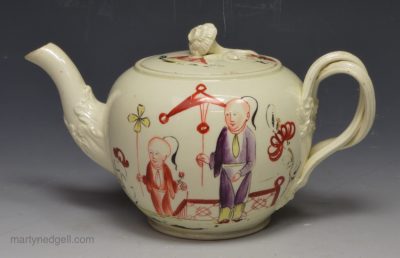 Very small creamware pottery teapot decorated with enamel over the glaze, circa 1770