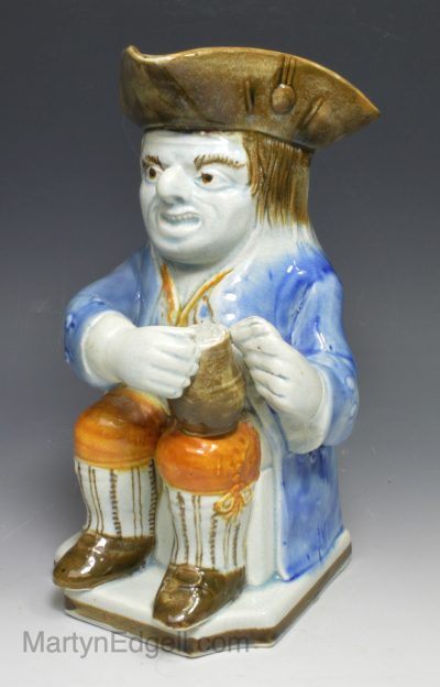 Prattware pottery Askew Toby jug decorated with colours under the glaze, circa 1820