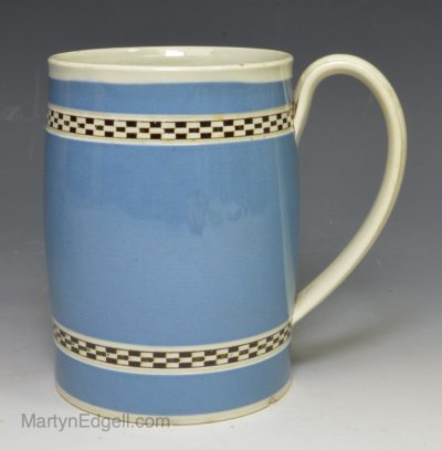Pearlware pottery mug decorated with blue slip and brown inlay checker, circa 1800