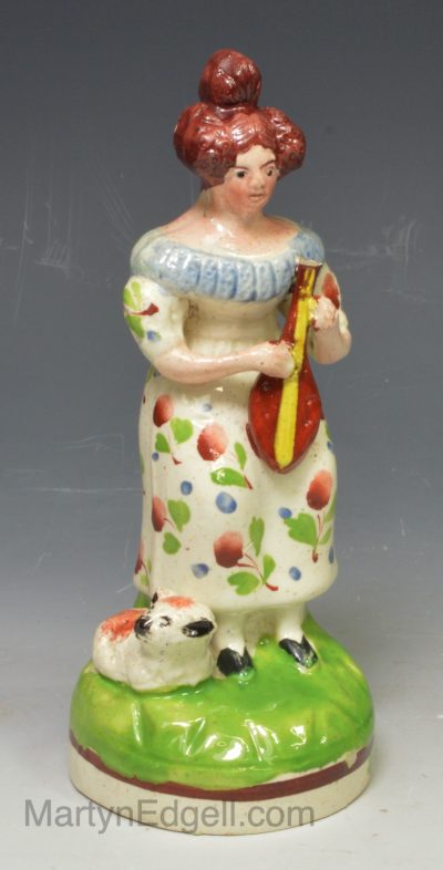 Staffordshire pearlware pottery figure of a lady holding a lute, circa 1820