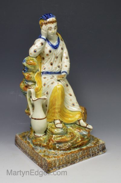Prattware pottery figure of a widow decorated with colours under the glaze, circa 1800